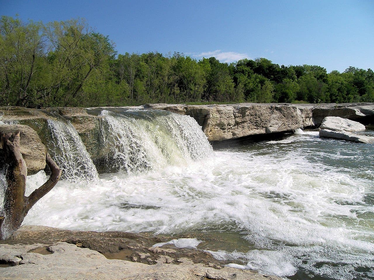 McKinney Falls State Park in southeast Austin — Onion Creek flowing over limestone ledges into a swimming pool