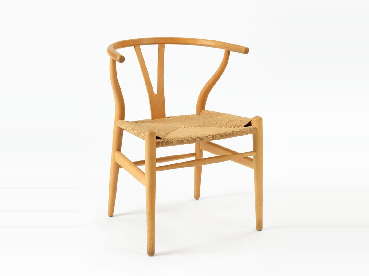 Hans J. Wegner Wishbone Chair in beech with a woven paper-cord seat, photographed on a plain light background