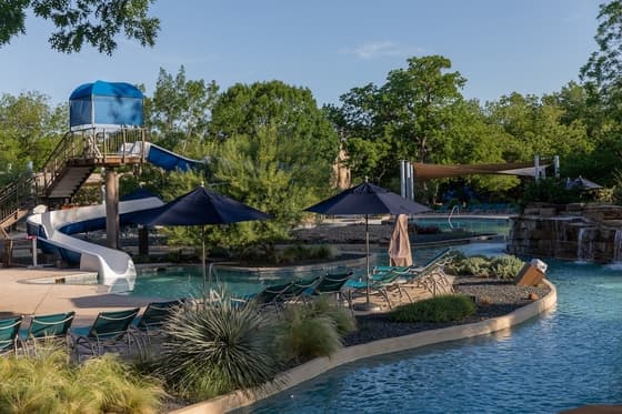 Hyatt Regency Lost Pines Resort's Crooked River lazy river winding through the 405-acre Lost Pines forest — the most complete day-pass experience in the Austin area