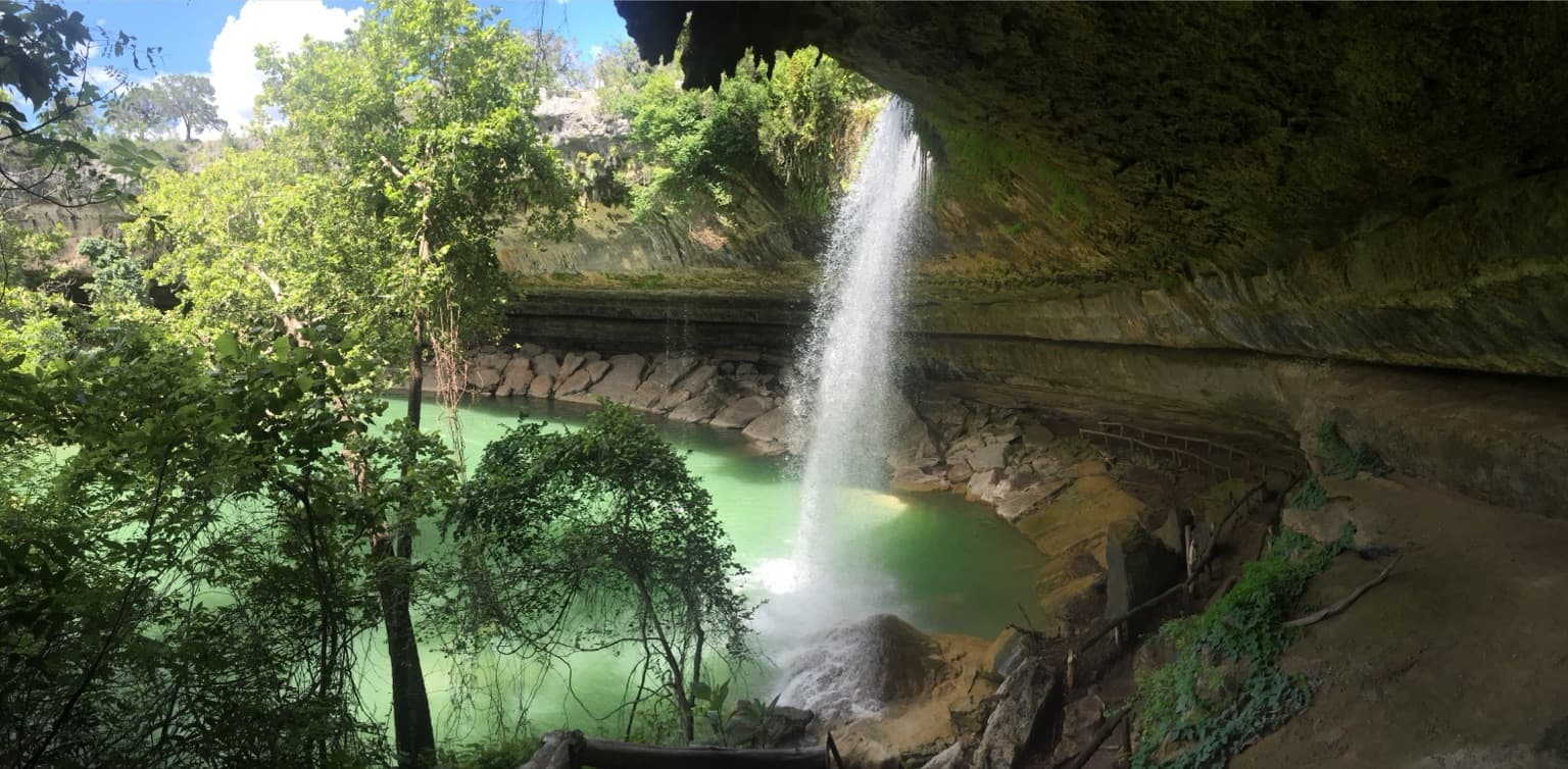 Water pouring over the limestone grotto rim into Hamilton Pool Preserve near Dripping Springs