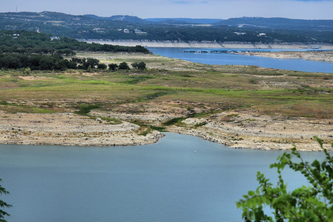Lake Travis threading between Hill Country ridges, running well below full pool in a drought year