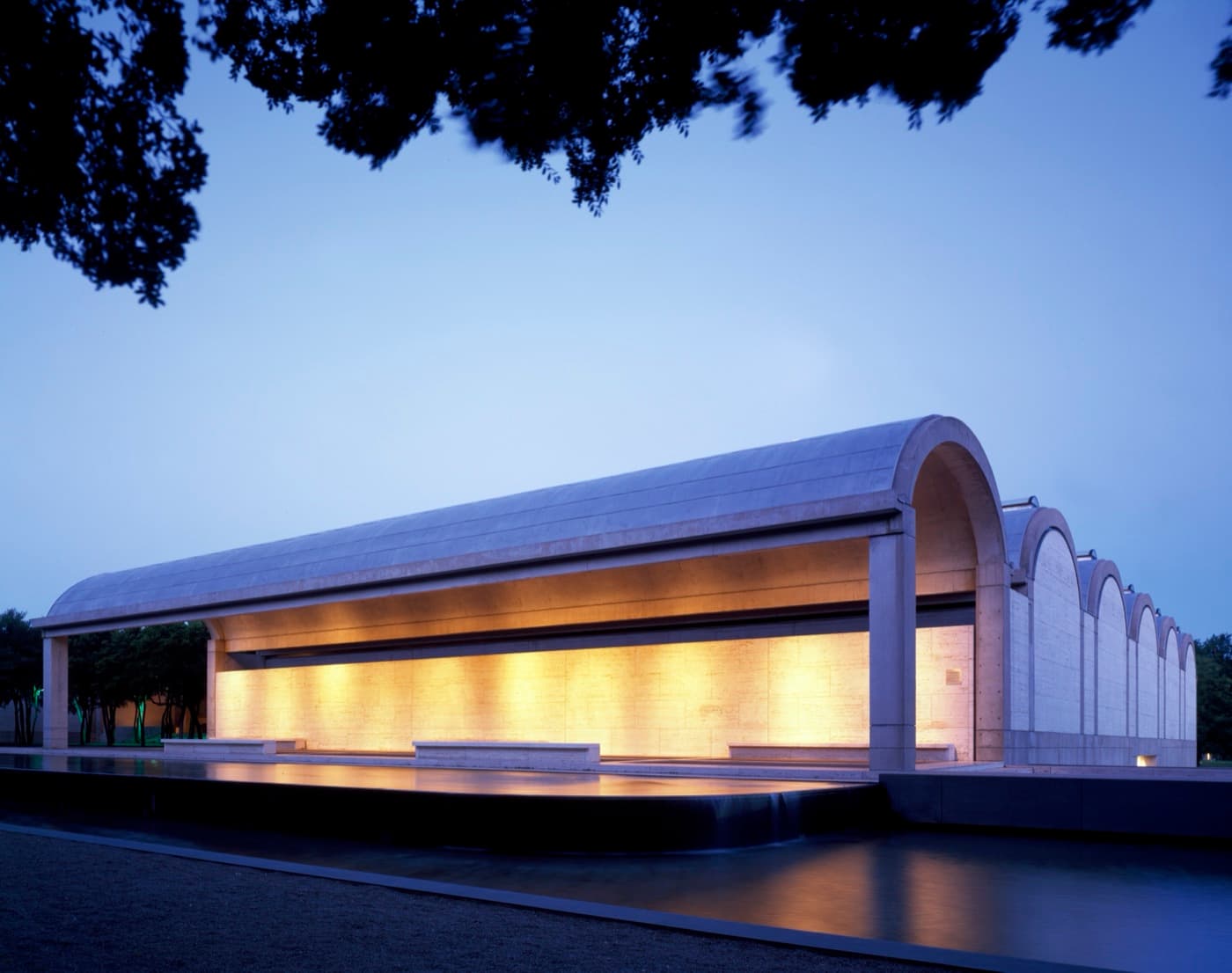 The vaulted south wing of the Kimbell Art Museum in Fort Worth's Cultural District at dusk