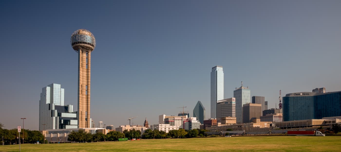Reunion Tower rising beside the downtown Dallas skyline