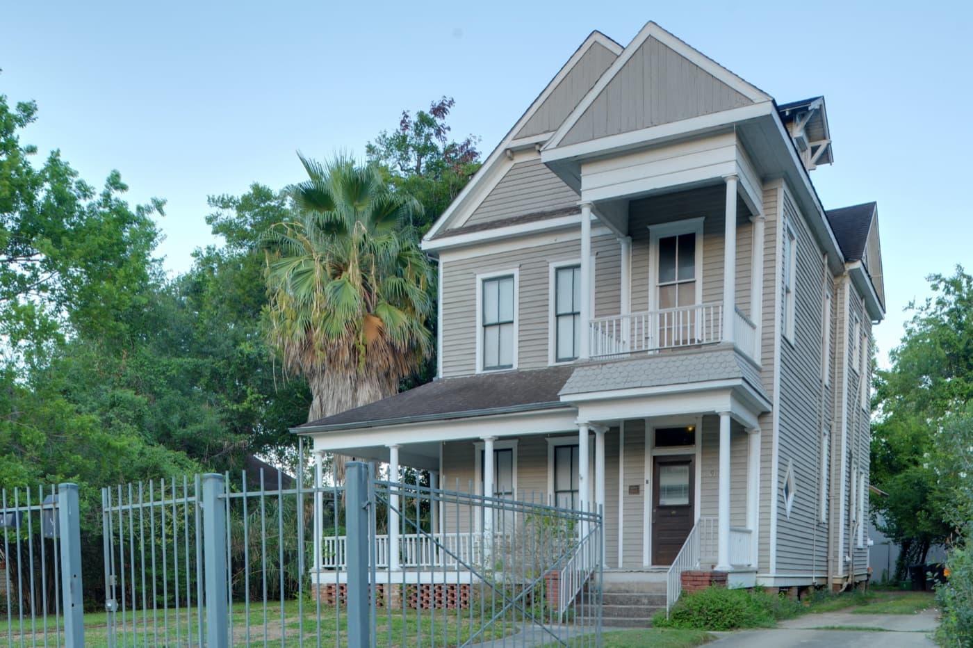 A restored Victorian house with a wraparound porch on Heights Boulevard in the Houston Heights