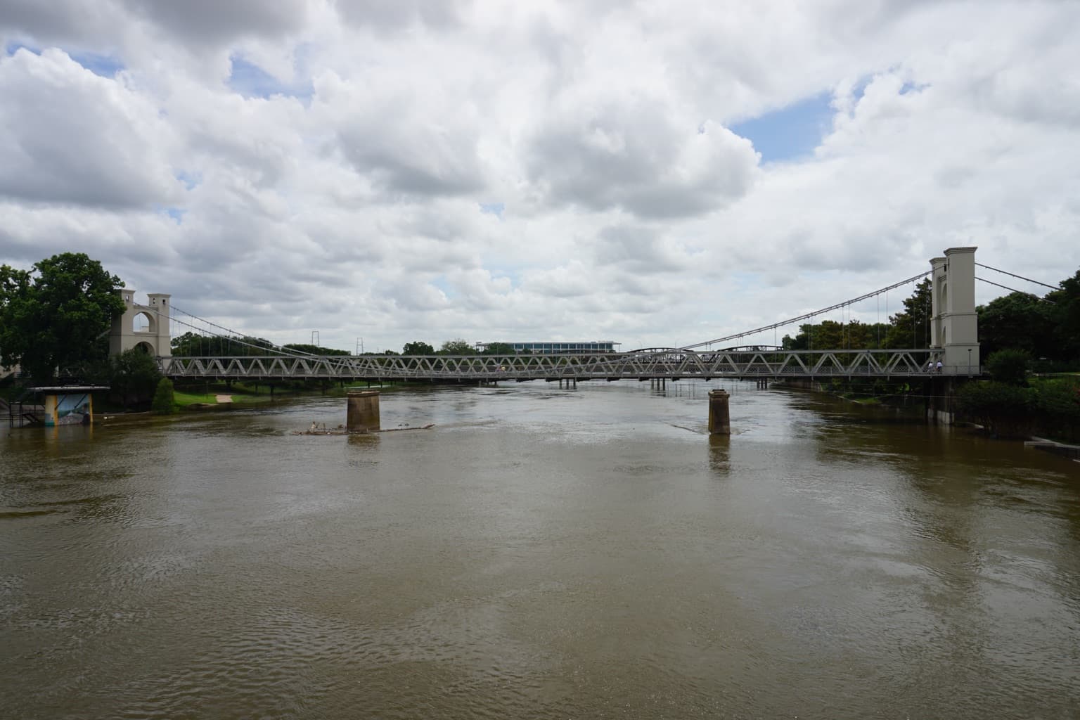 The twin brick towers and cables of the Waco Suspension Bridge over the Brazos River