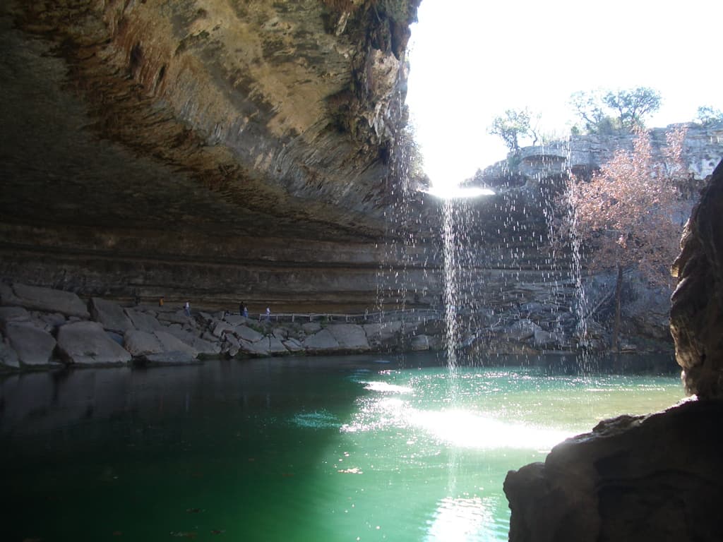Hamilton Pool Preserve in Dripping Springs — the half-dome limestone grotto with a 50-foot waterfall feeding a turquoise pool