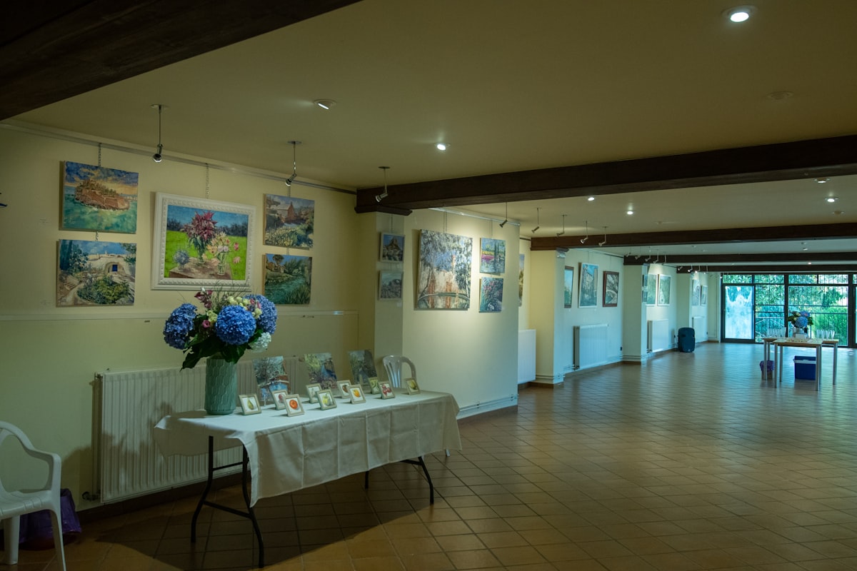 Gallery interior with carefully curated artwork displayed on white walls with professional lighting