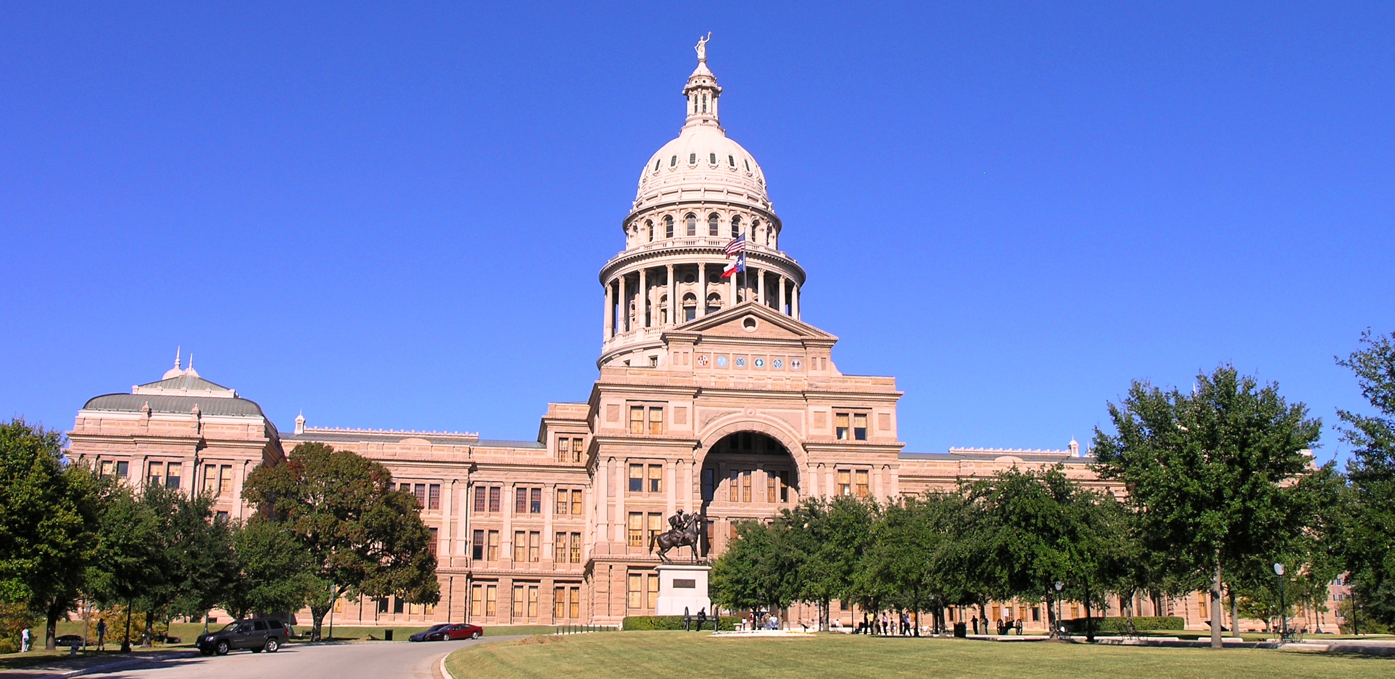 The Texas State Capitol building in Austin, surrounded by monuments and sculptural installations on its grounds