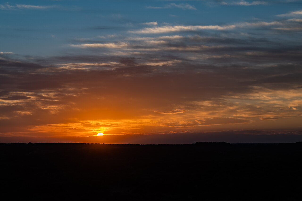 Sunset over the limestone terraces at Pedernales Falls State Park — where Hill Country geology meets wildflower season