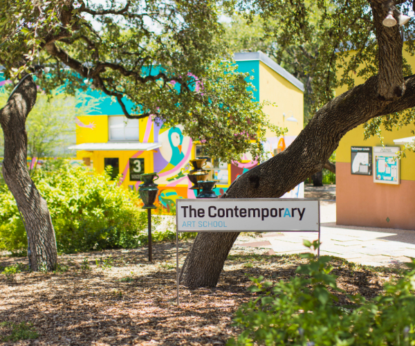 Contemporary sculpture installations on the wooded grounds at Laguna Gloria with Lake Austin in the background
