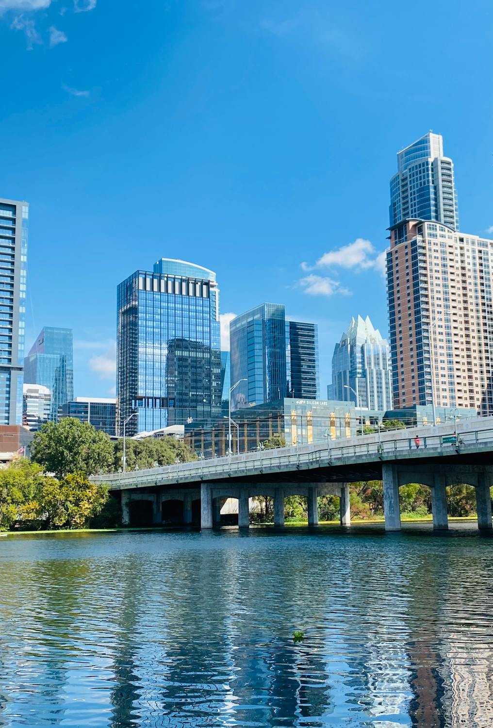The Austin skyline and river — a city transformed by tech growth, immigration, and the visa programs that connect them