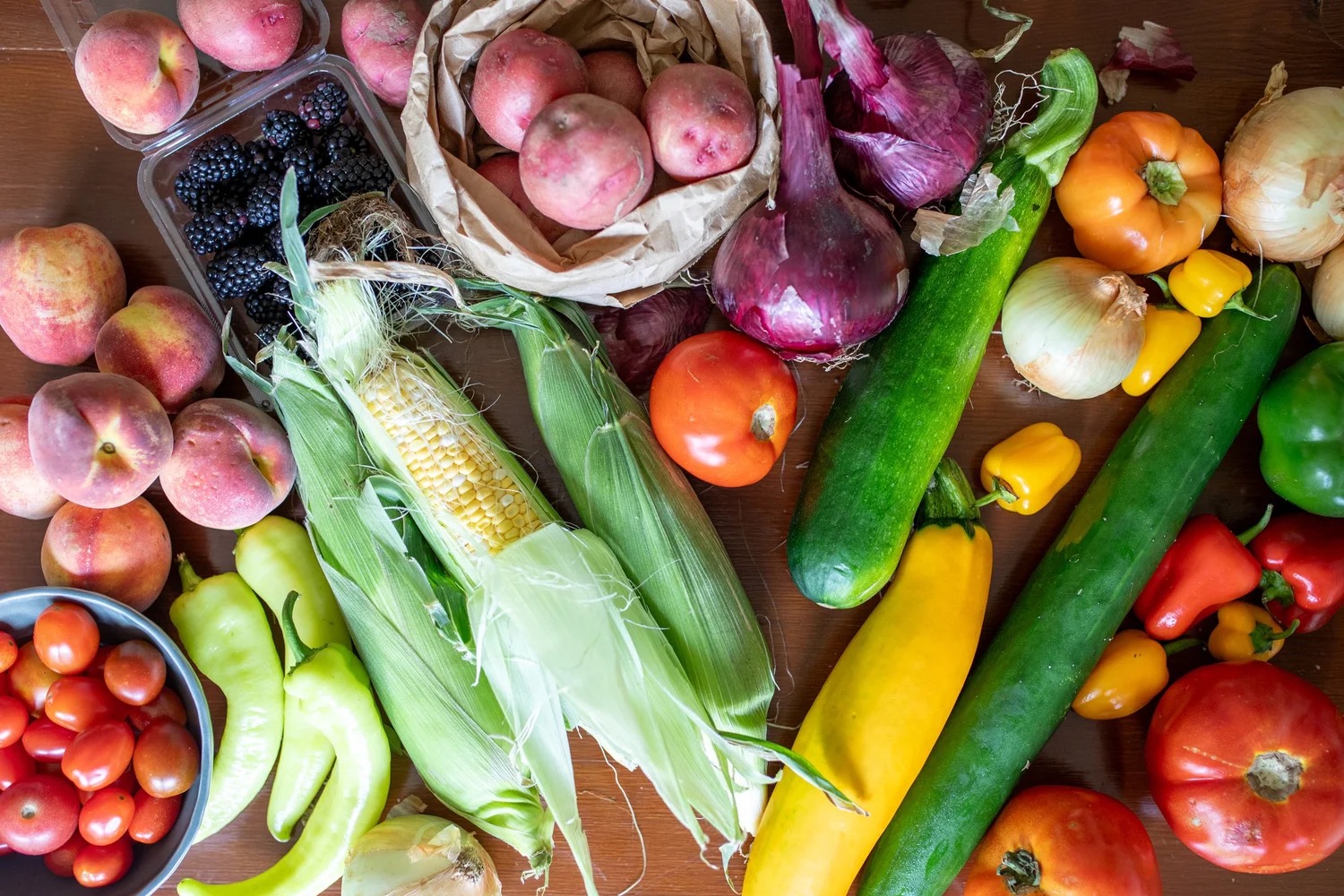 A market haul from the Texas Farmers' Market — fresh peaches, local produce, artisan goods, all bought directly from the people who grew them