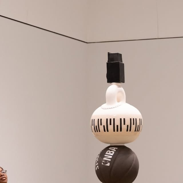 A visitor gazing up at a contemporary sculpture installation in LACMA's new David Geffen Galleries