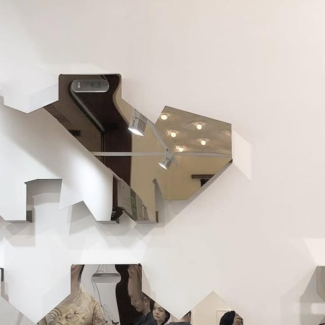 A mirrored geometric art installation in a gallery — shared by The Art Gorgeous on Instagram