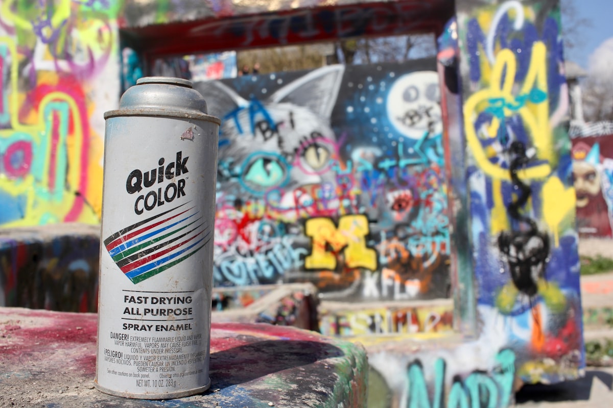 Spray paint cans and colorful graffiti at HOPE Outdoor Gallery in Austin