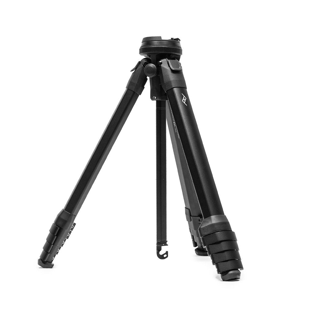 Peak Design Travel Tripod Carbon Fiber in compact folded form — the patented triangular leg geometry that disappears into a Nalgene-sized footprint