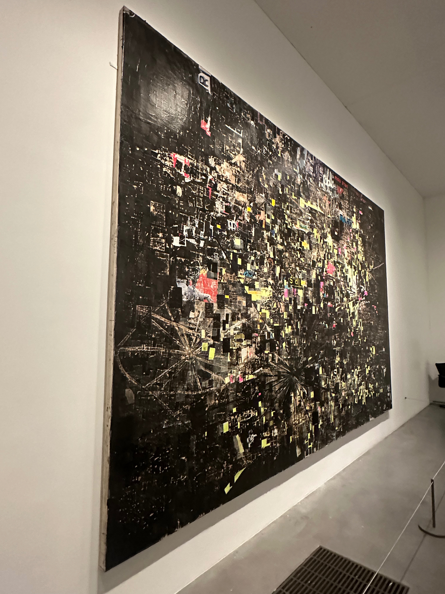 Large abstract painting with dark background and colorful accents