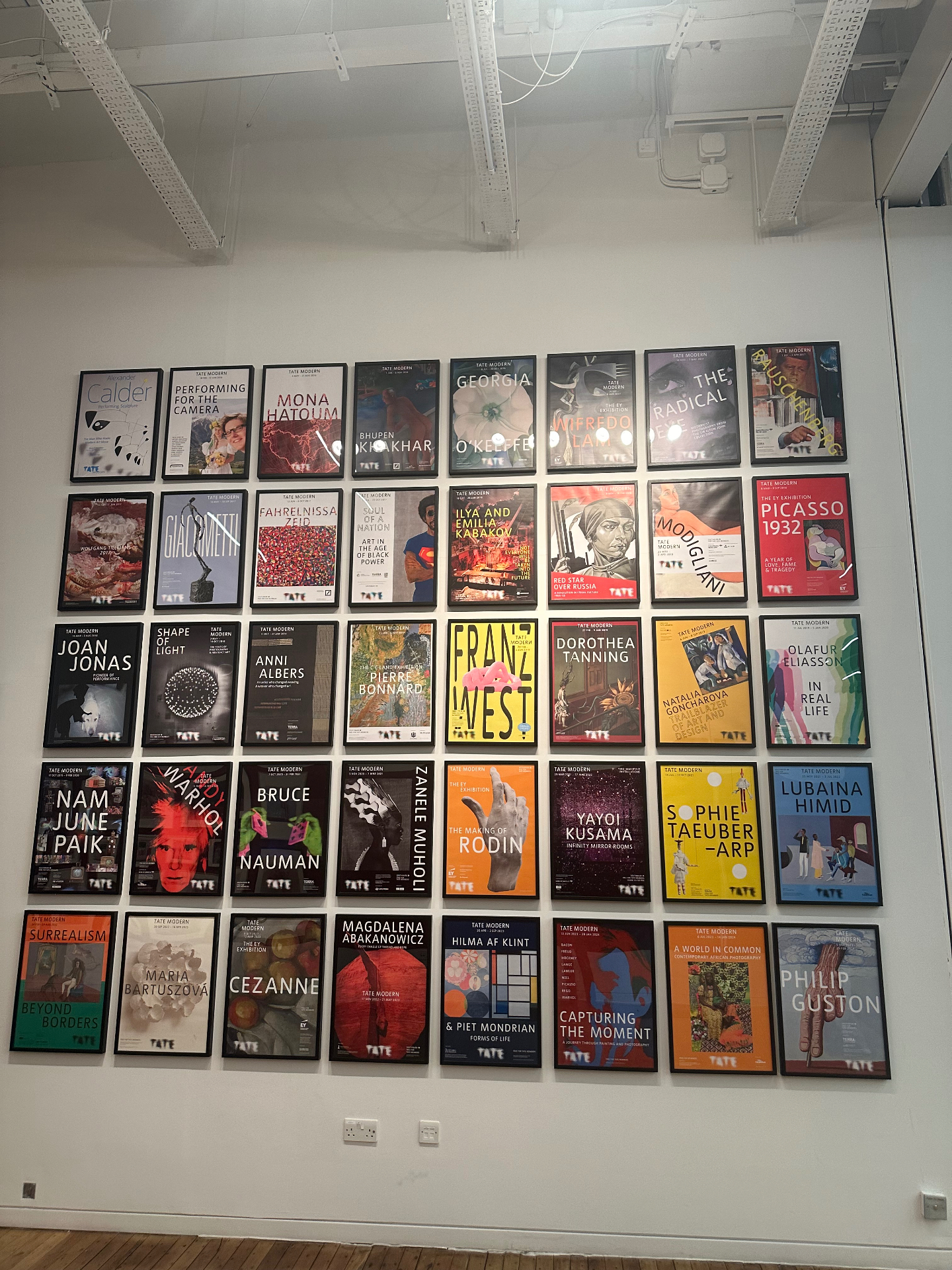 Wall of Tate Modern exhibition posters showing the museum's remarkable programming history