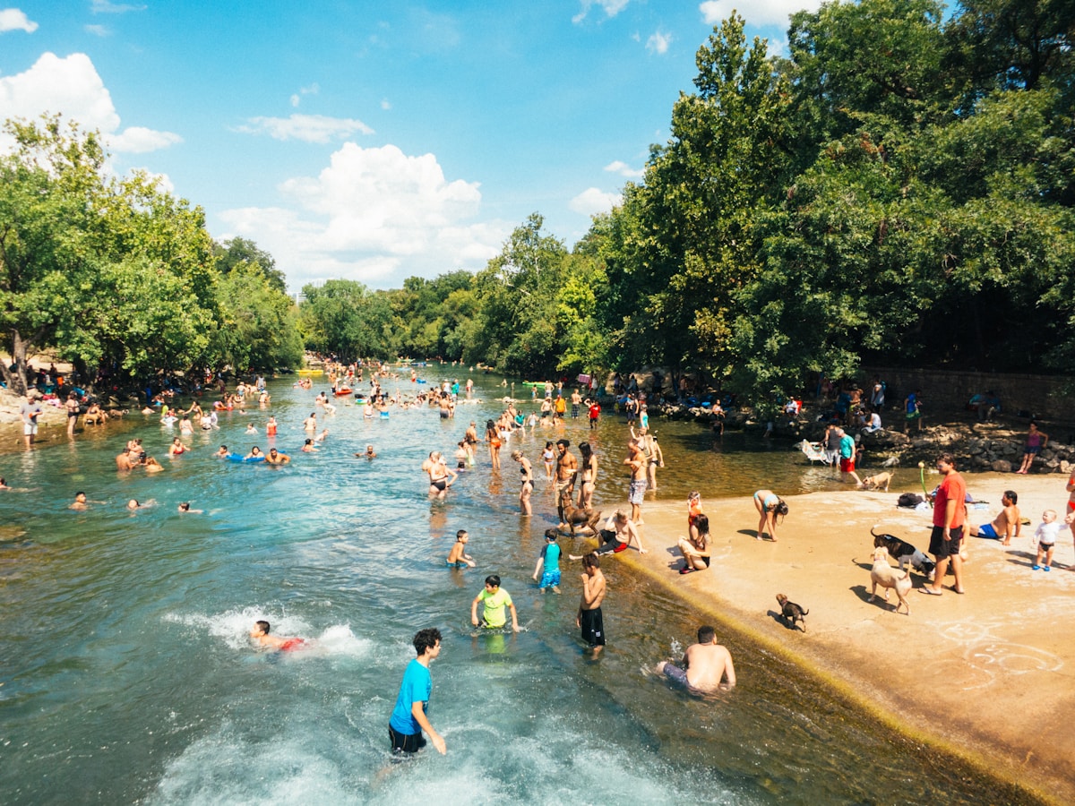 Swimmers enjoying Barton Springs Pool in Austin, Texas on a sunny day