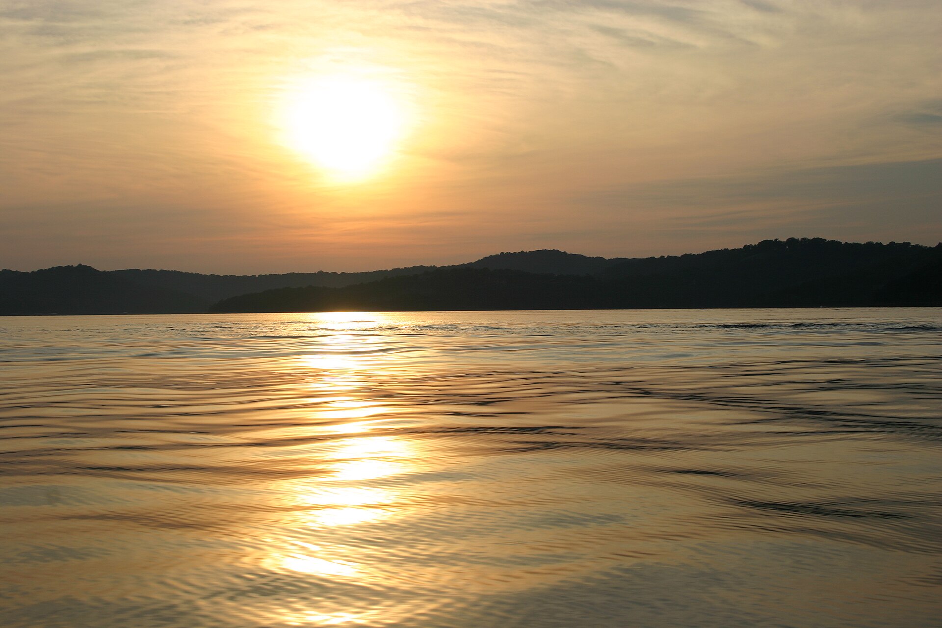 Limestone bluffs rising from clear green water on Beaver Lake, Arkansas