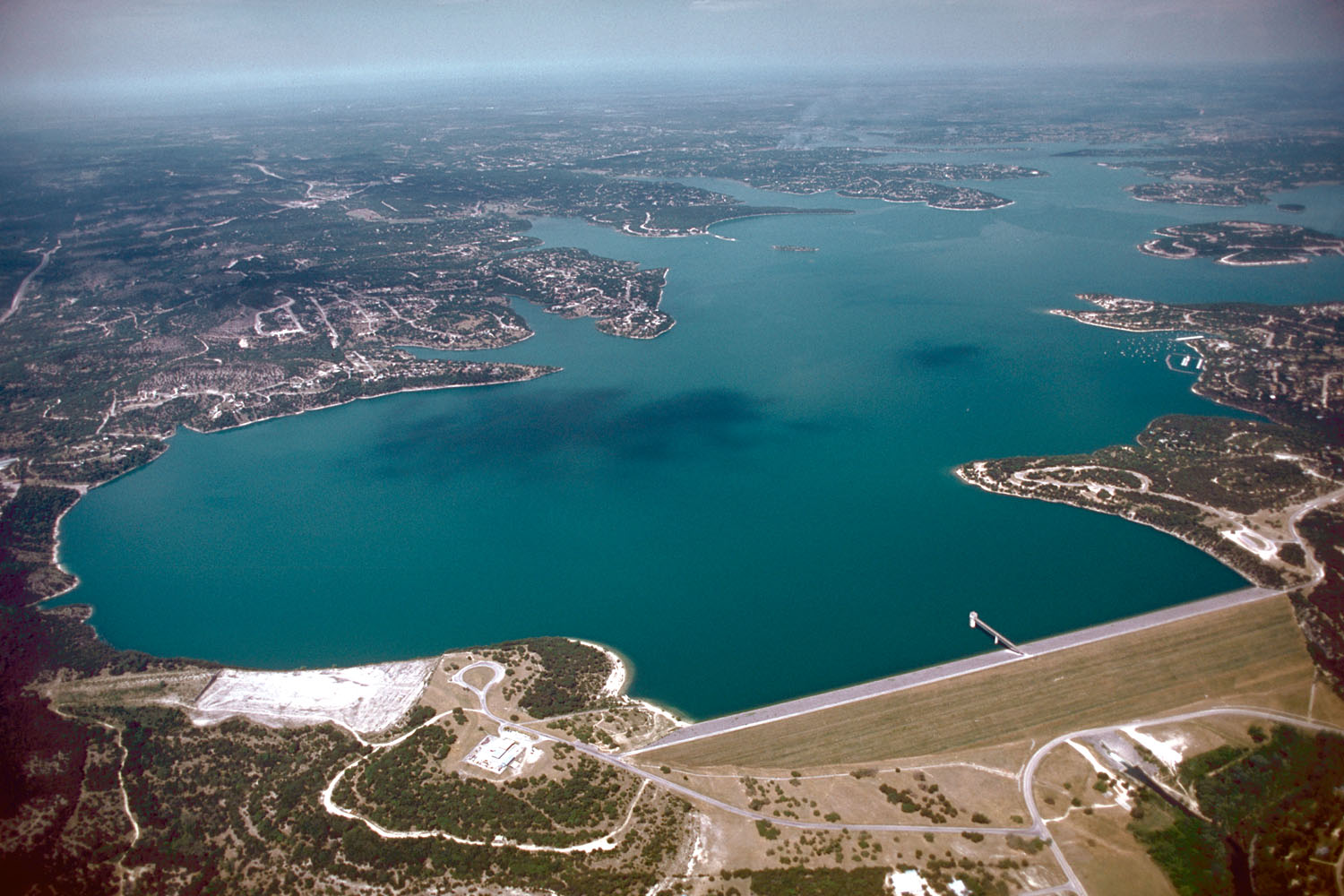 Clear blue water and Hill Country ridgelines around a quiet cove on Canyon Lake, Texas