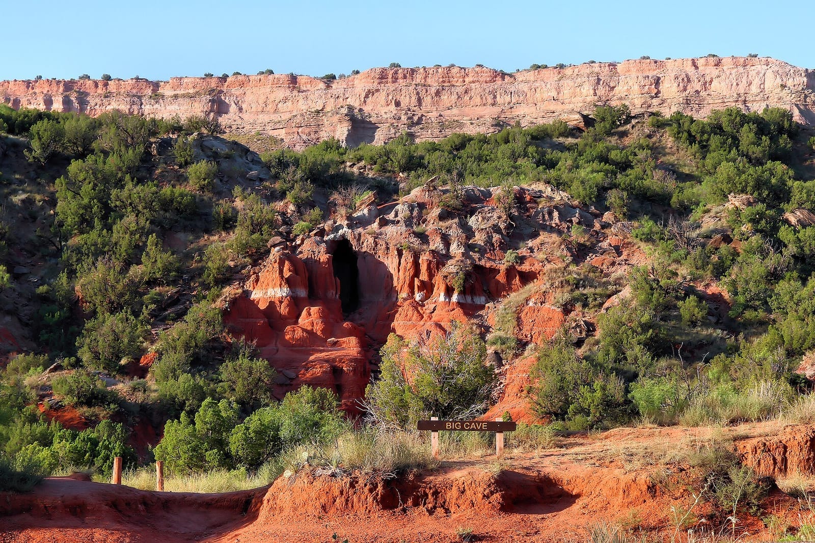 Sunrise light igniting the red rock walls seen from the rim of Palo Duro Canyon