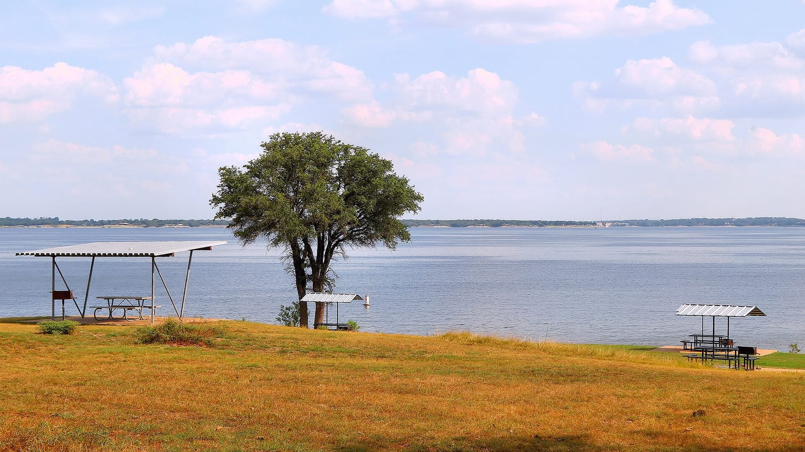 Limestone bluffs walling the deep green water of Lake Whitney's west shore