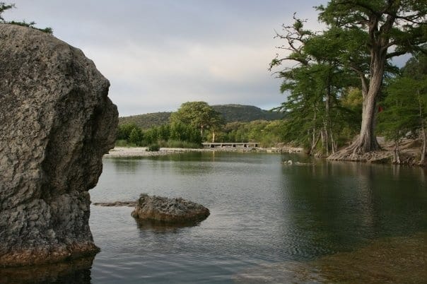 Clear green water of the Frio River shaded by hundred-year cypress at Concan