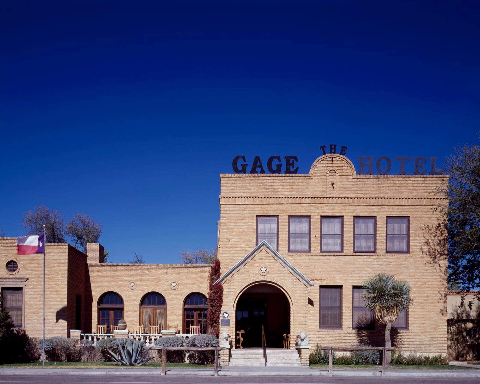 A quiet street of adobe and stone buildings in Marathon under a wide West Texas sky