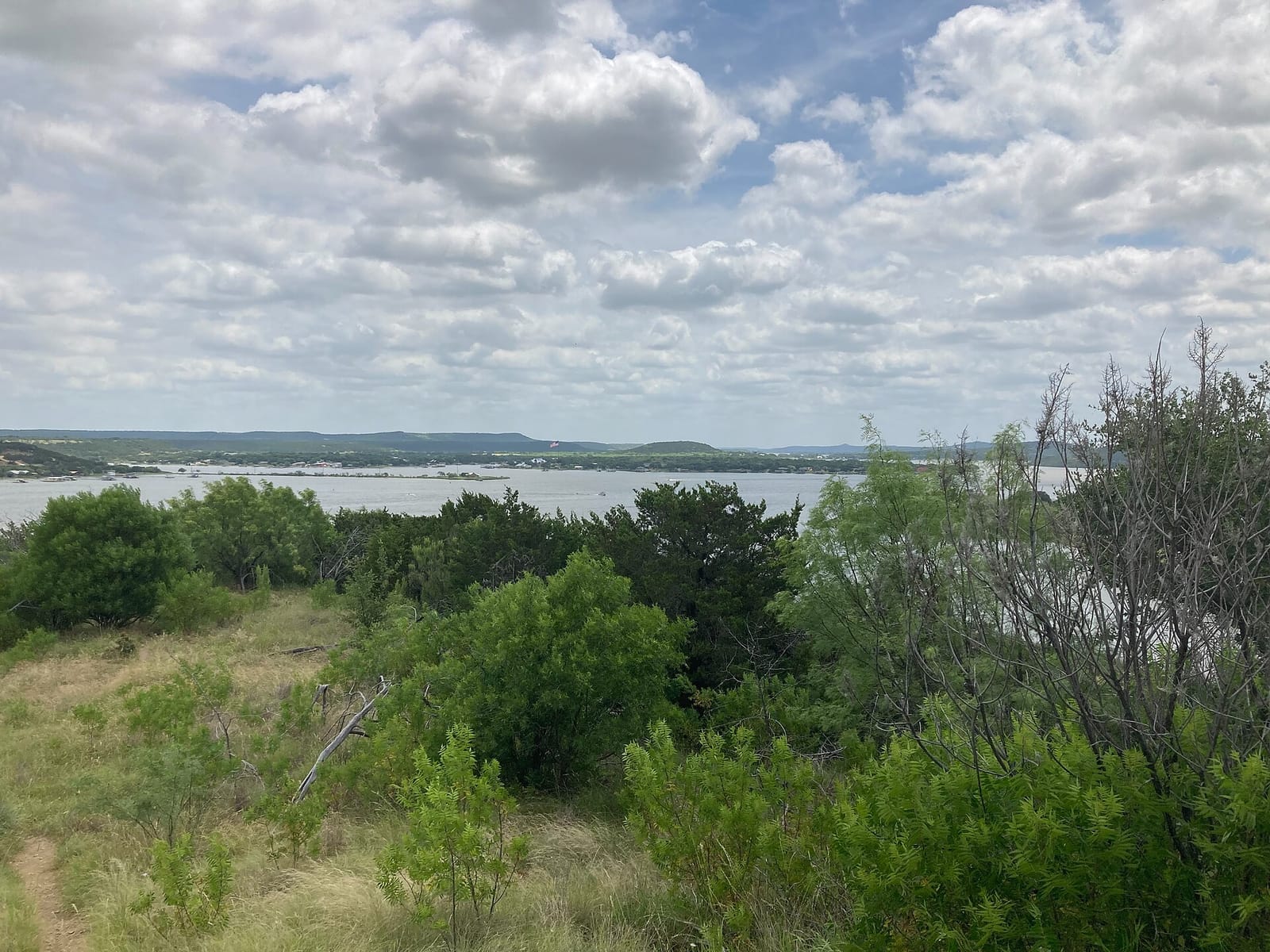 Clear blue-green water and limestone canyon shoreline at Possum Kingdom Lake