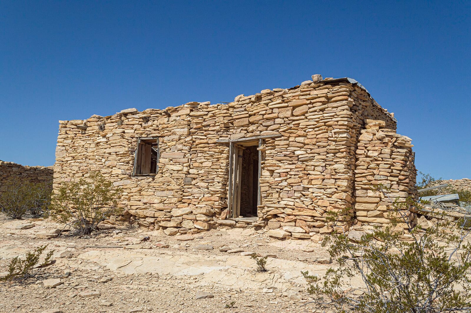 Adobe ruins of Terlingua Ghost Town with the Chisos Mountains on the horizon
