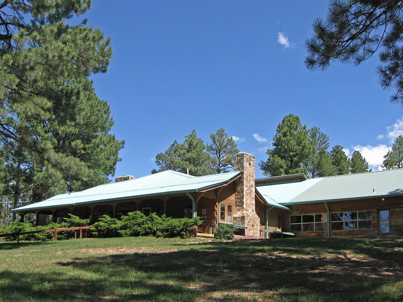 Scattered cabins in open pine high country under a big sky in Timberon, New Mexico