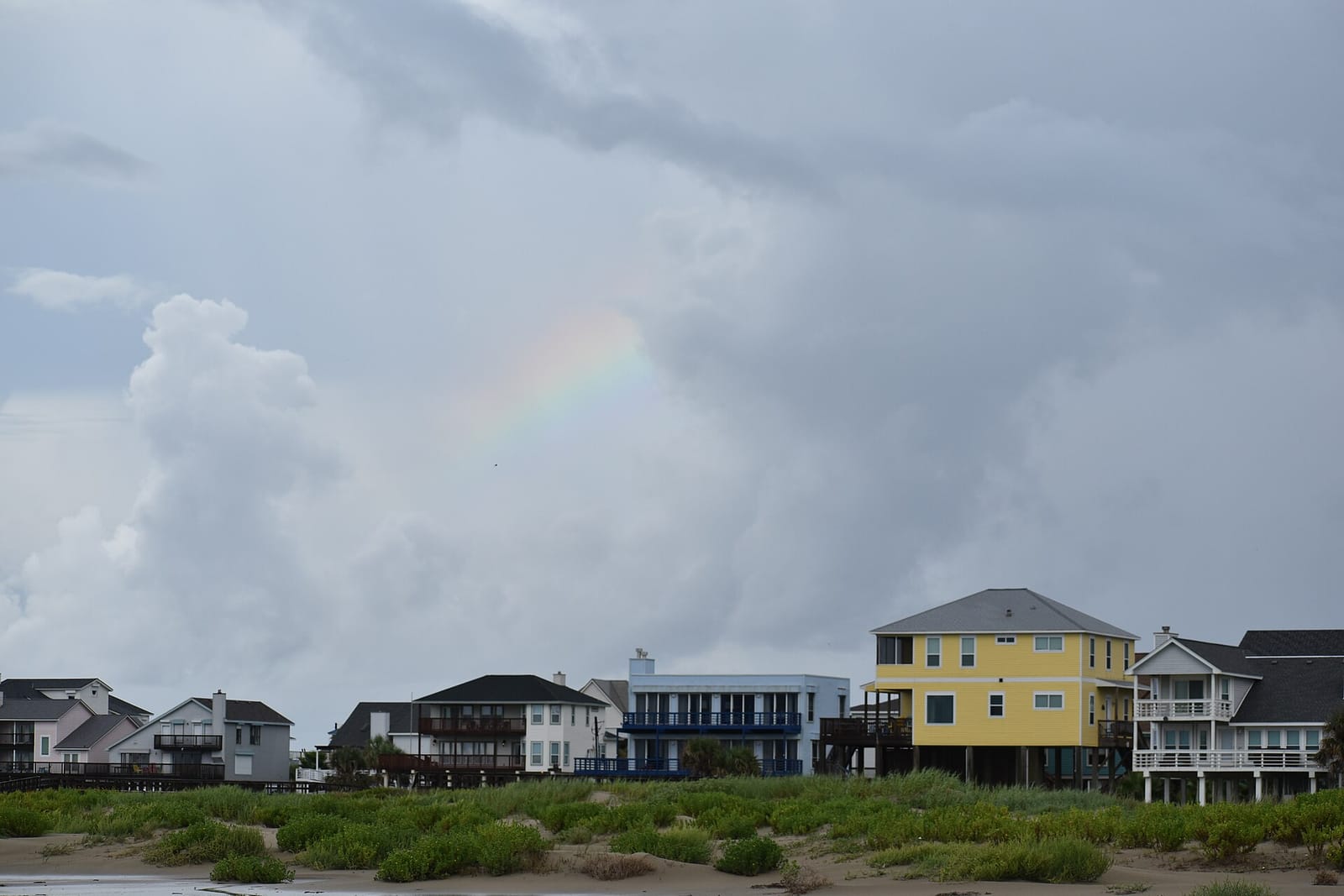 Rows of stilted beach houses near the sand on Galveston's West End